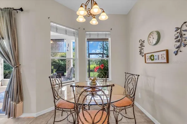 a view of a dining room with furniture and a chandelier