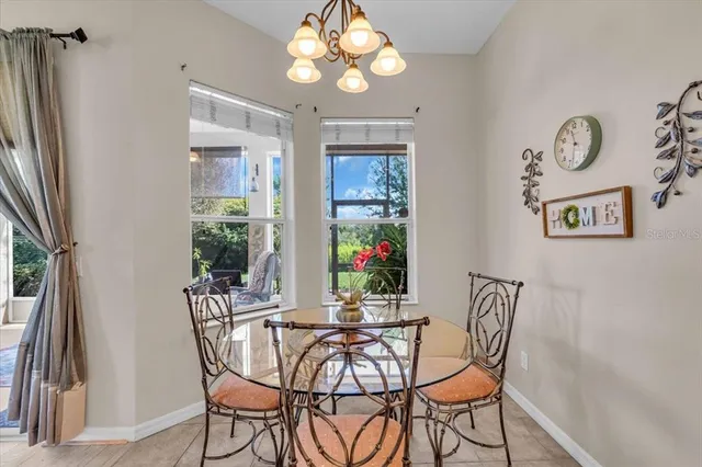 a view of a dining room with furniture and a chandelier