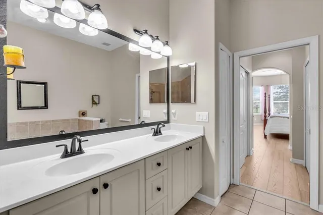 a bathroom with a double vanity sink and a mirror