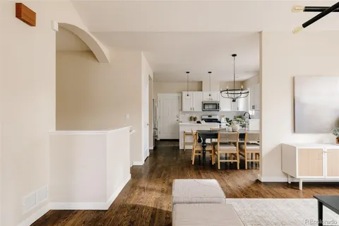 a dining room with furniture and wooden floor