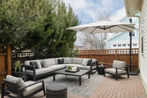 a terrace with outdoor seating and trees
