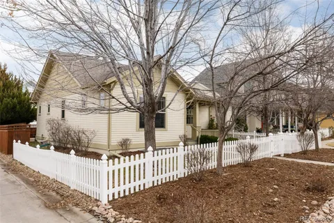 a view of a house with a yard covered with snow