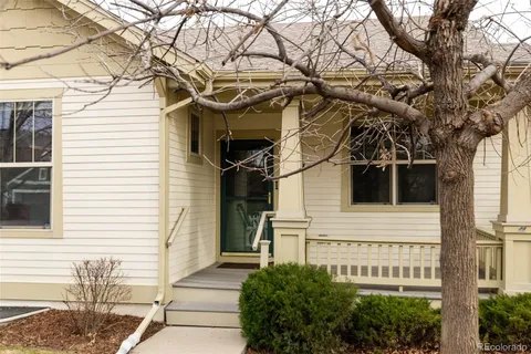 a view of a white house with a large tree