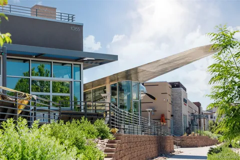 a view of a chair and tables in the patio and a fountain