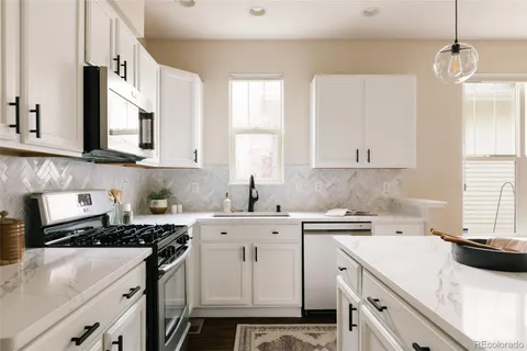 a kitchen with a sink stove and cabinets