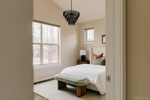 a bed sitting in a bedroom next to a window