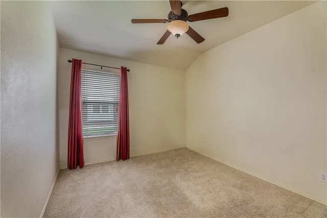 an empty room with closet and windows