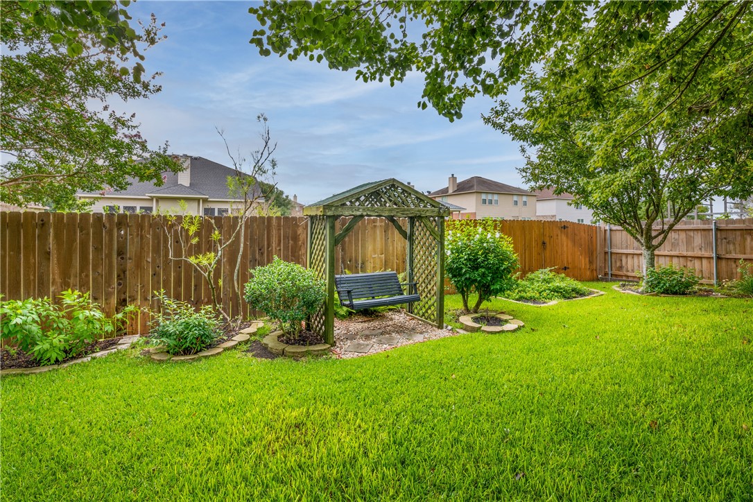114 Inman Drive Hutto, TX 78634 - Photo 20 of 20 a view of a garden in front of a house