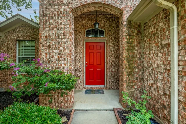 a front view of a house with a red gate