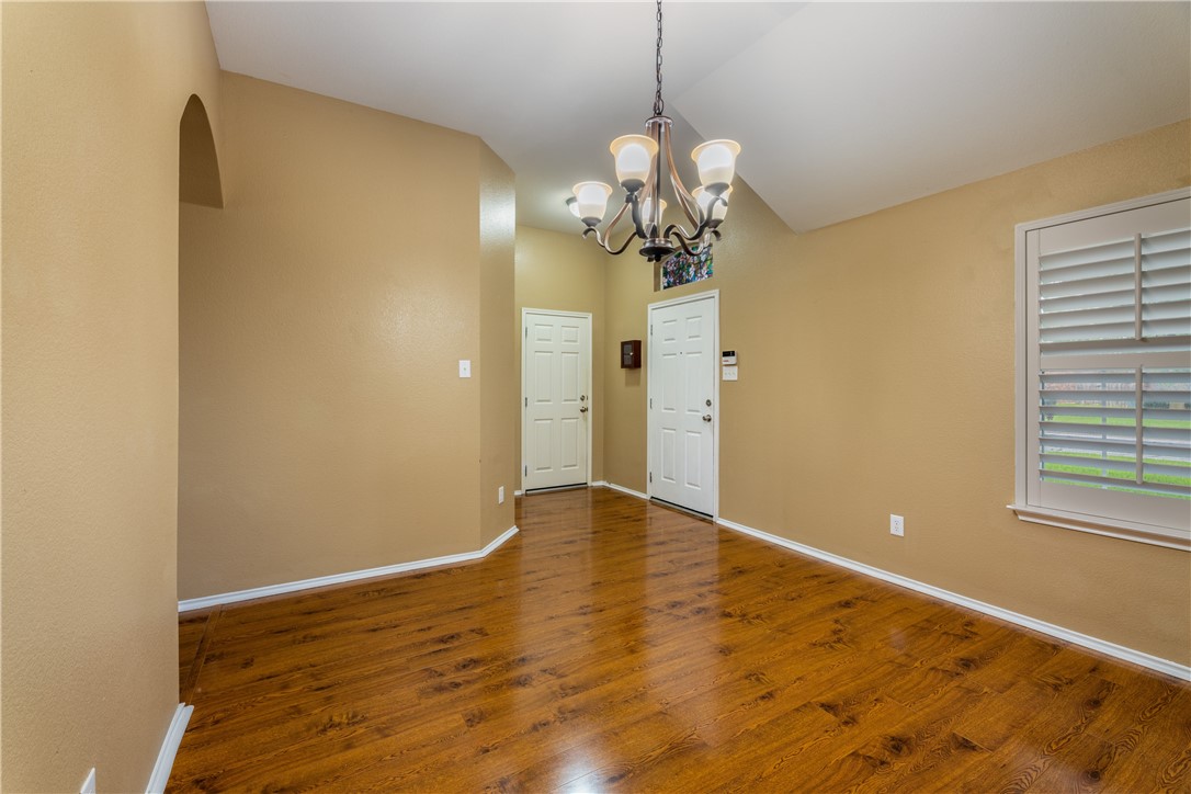 114 Inman Drive Hutto, TX 78634 - Photo 5 of 20 a view of empty room with wooden floor and chandelier
