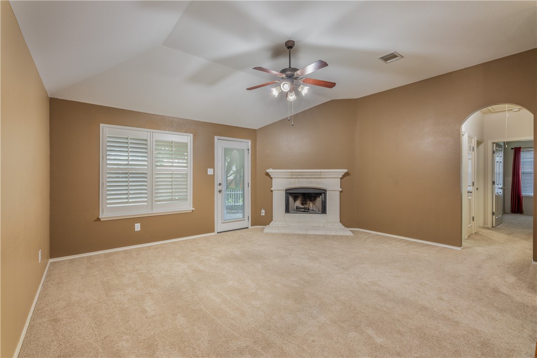 114 Inman Drive Hutto, TX 78634 - Photo 8 of 20 a view of an empty room with chandelier fan and fire place