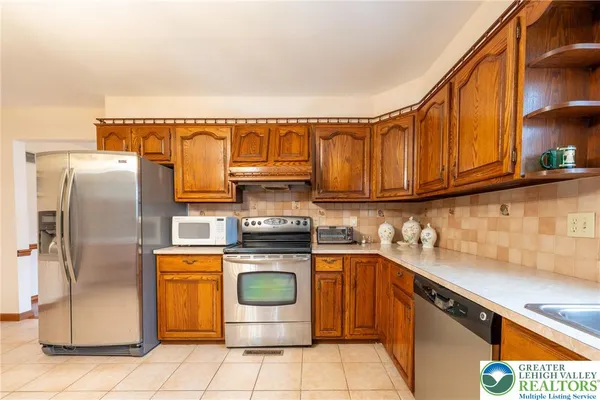 a dining hall with stainless steel appliances a dining table and chairs