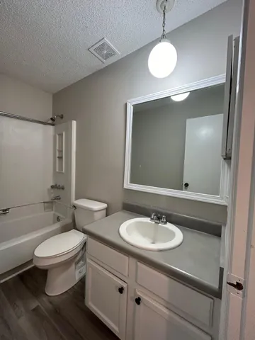 a bathroom with a sink toilet tub and shower