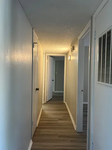 a view of hallway with wooden floor
