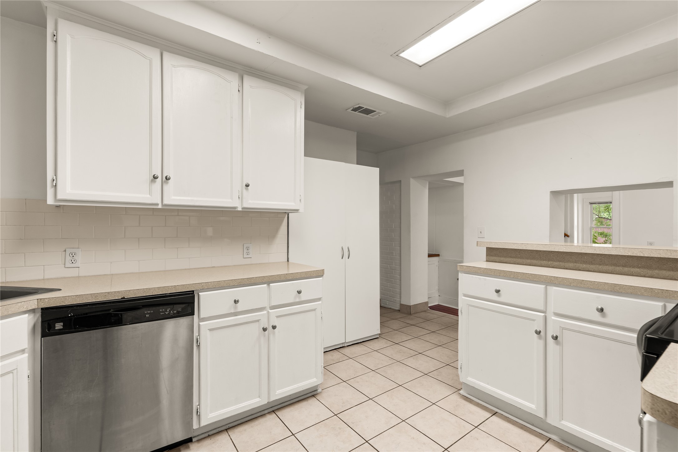 2202 West Main Street Houston, TX 77098 - Photo 11 of 32 a kitchen with white cabinets and white appliances