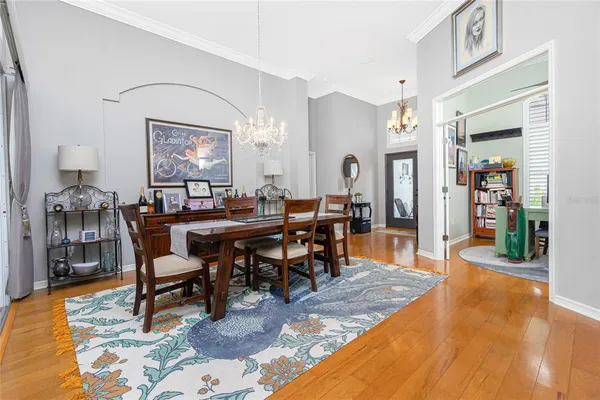 a living room with furniture a rug and a chandelier