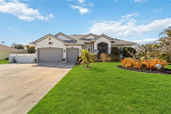 a front view of a house with a garden and yard