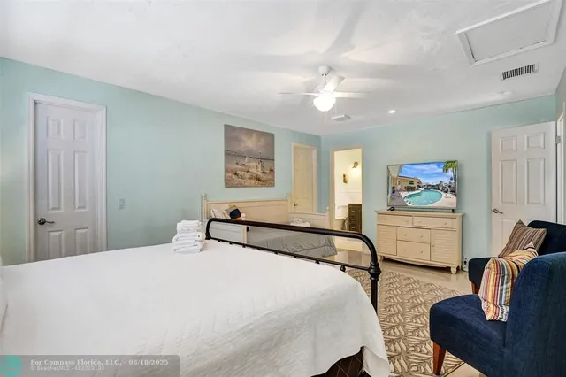 a bedroom with bed and a chandelier