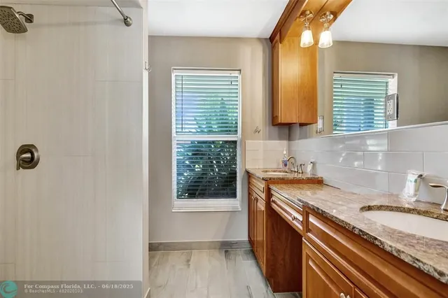 a open kitchen with granite countertop a sink and a stove next to a window