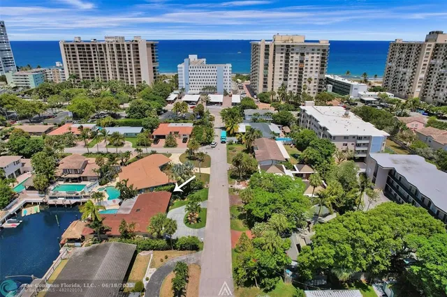 an aerial view of a house with a yard and garden