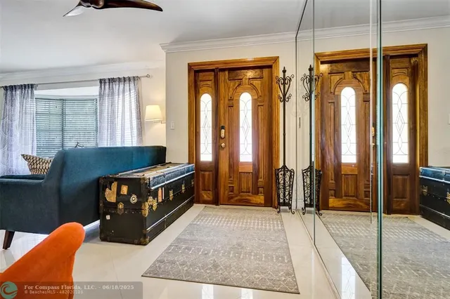 a view of hallway with furniture and windows