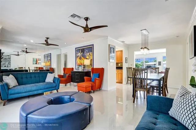 a living room with furniture wooden floor and a chandelier
