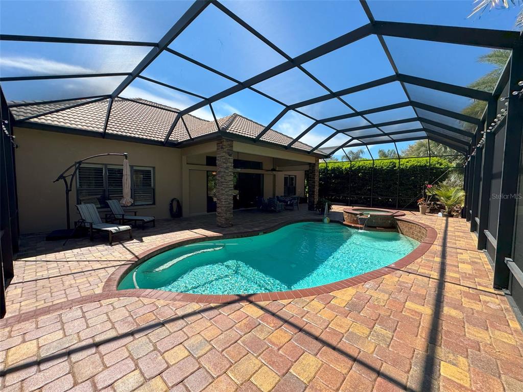 1024 West Beagle Run Loop Hernando, FL 34442 - Photo 39 of 44 a view of a backyard with table and chairs under an umbrella