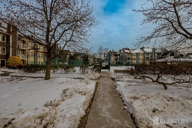 a view of a yard covered with snow in front of house