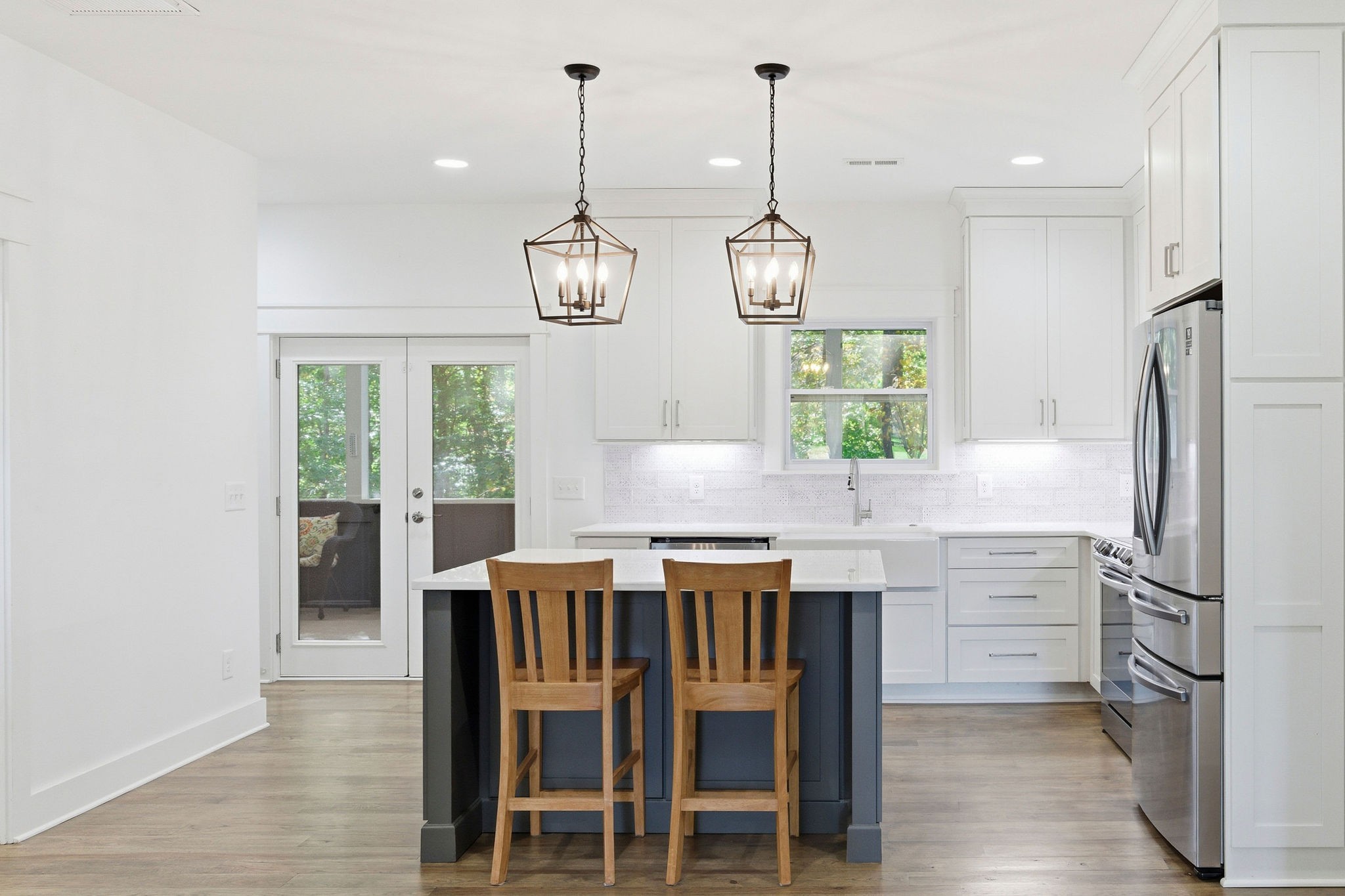 5616 Pinewood Road Franklin, TN 37064 - Photo 66 of 82 a kitchen with a table chairs refrigerator and microwave