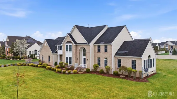 a aerial view of a house with swimming pool next to a yard