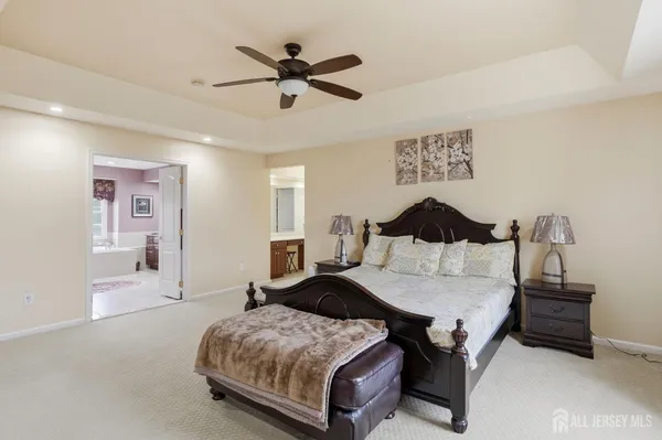 a bedroom with a bed and ceiling fan