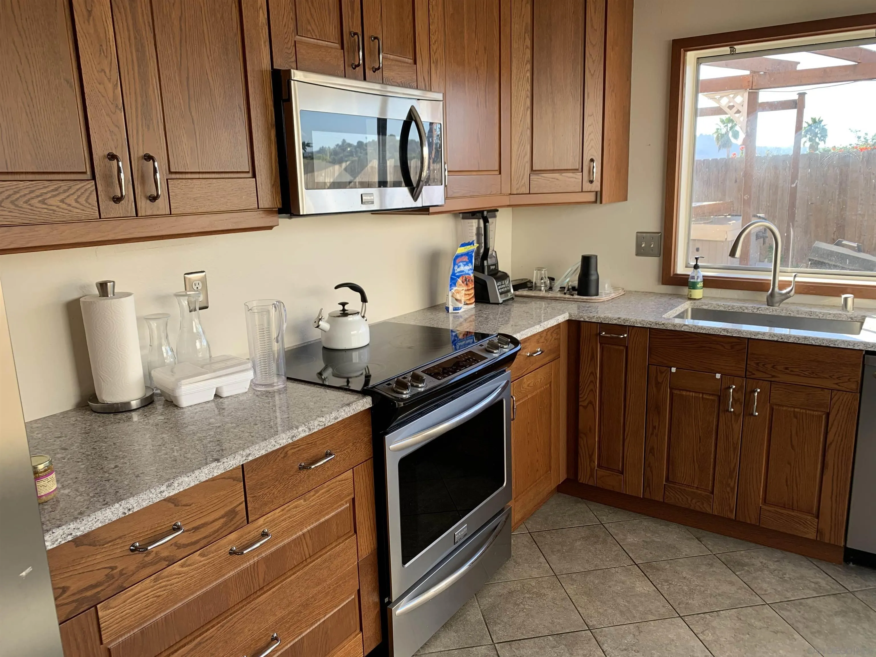 2332 Bar Bit Road Spring Valley, CA 91978 - Photo 5 of 15 a kitchen with stainless steel appliances granite countertop a sink stove and cabinets