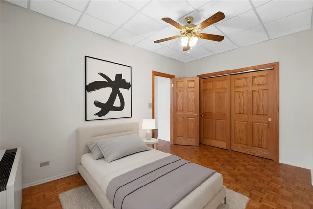 a bedroom with a large bed and a chandelier