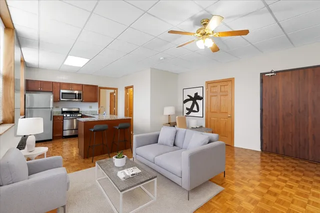 a living room with furniture and kitchen view