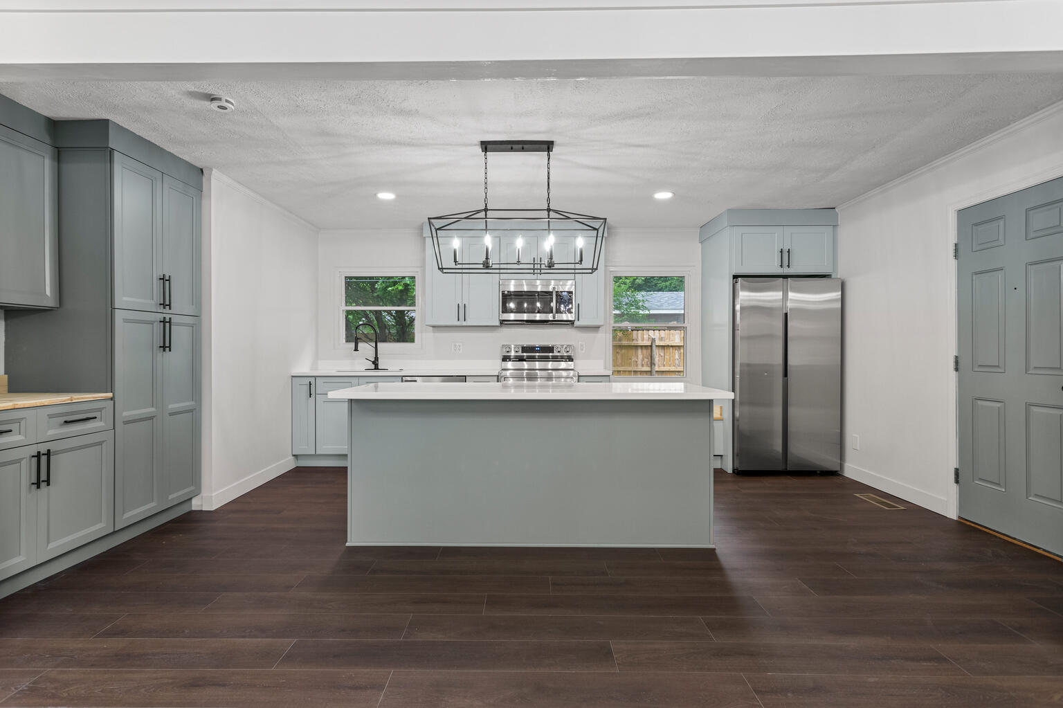 1802 Meadow Drive Champaign, IL 61821 - Photo 3 of 30 a large kitchen with granite countertop a large counter top stainless steel appliances and cabinets