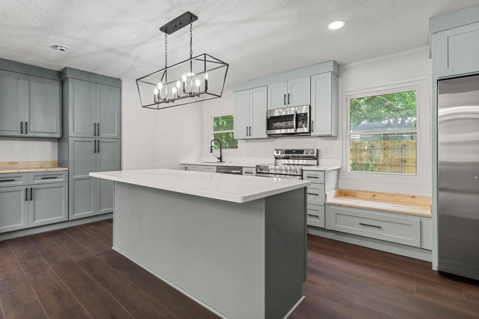 1802 Meadow Drive Champaign, IL 61821 - Photo 5 of 30 a kitchen with kitchen island granite countertop a sink cabinets and stainless steel appliances