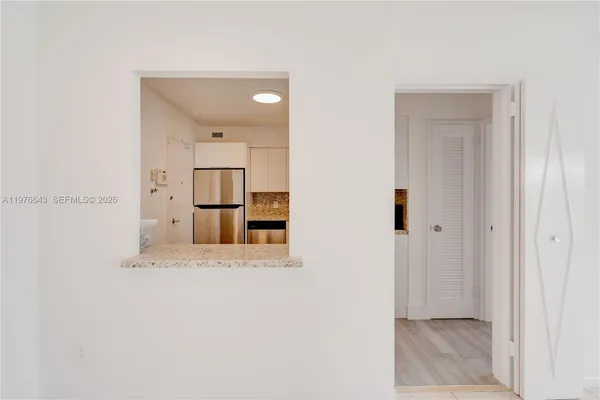 a white refrigerator freezer sitting inside of a kitchen