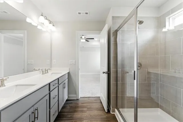 a bathroom with a double vanity sink and mirror