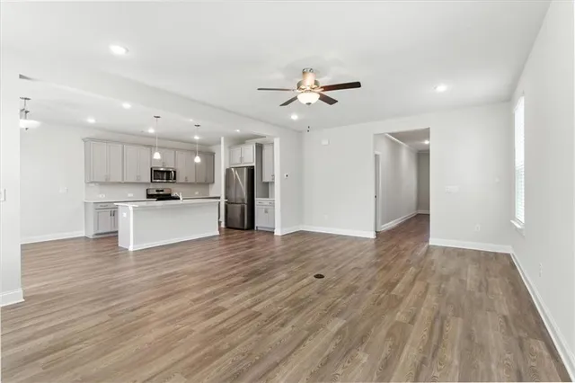 a view of a kitchen with a sink and a refrigerator