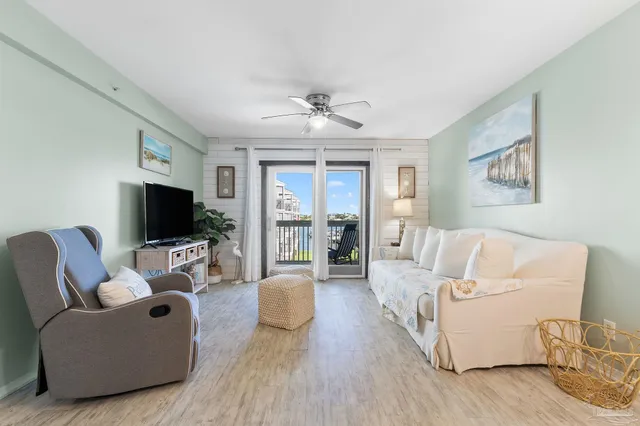 a living room with furniture wooden floor and a flat screen tv