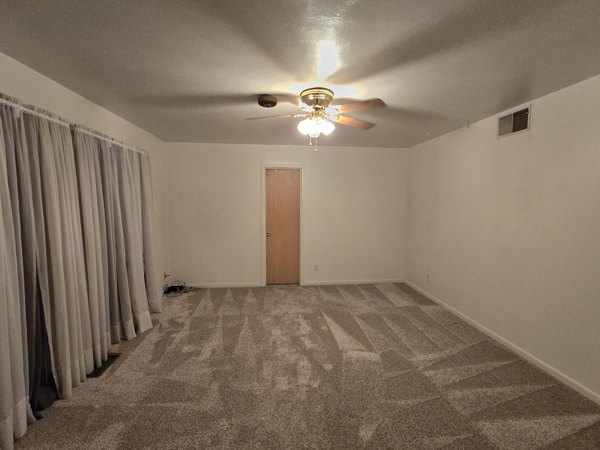 2229 South 6th Street Lamesa, TX 79331 - Photo 11 of 27 en empty room with windows and fan