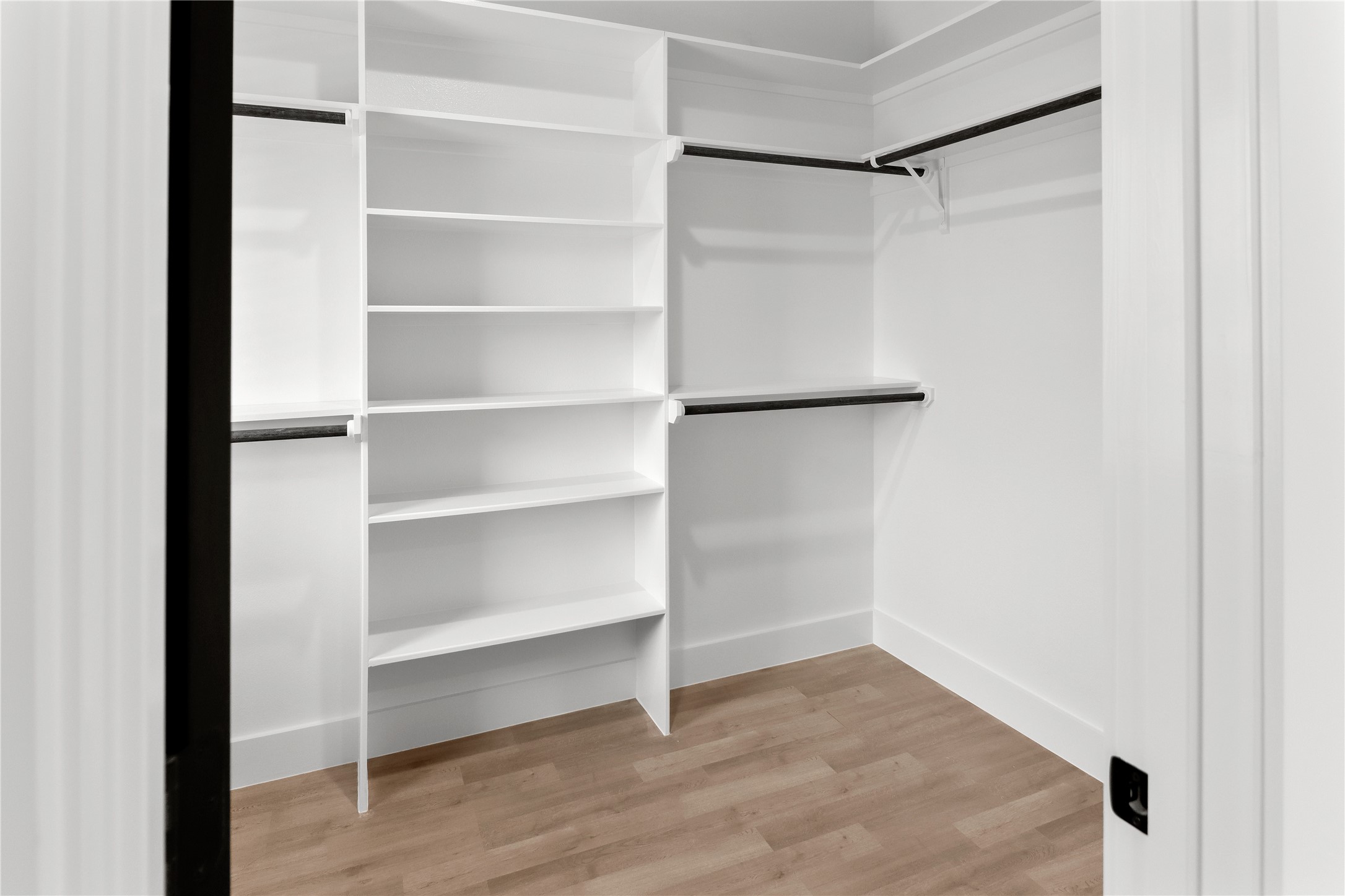 8136 Chateau Street Houston, TX 77028 - Photo 17 of 33 a view of an empty walk in closet with empty racks