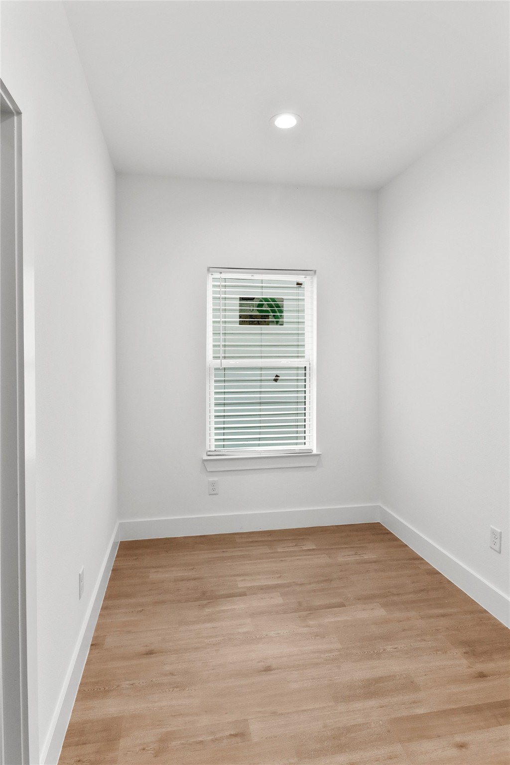 8136 Chateau Street Houston, TX 77028 - Photo 19 of 33 a view of an empty room with wooden floor and a window