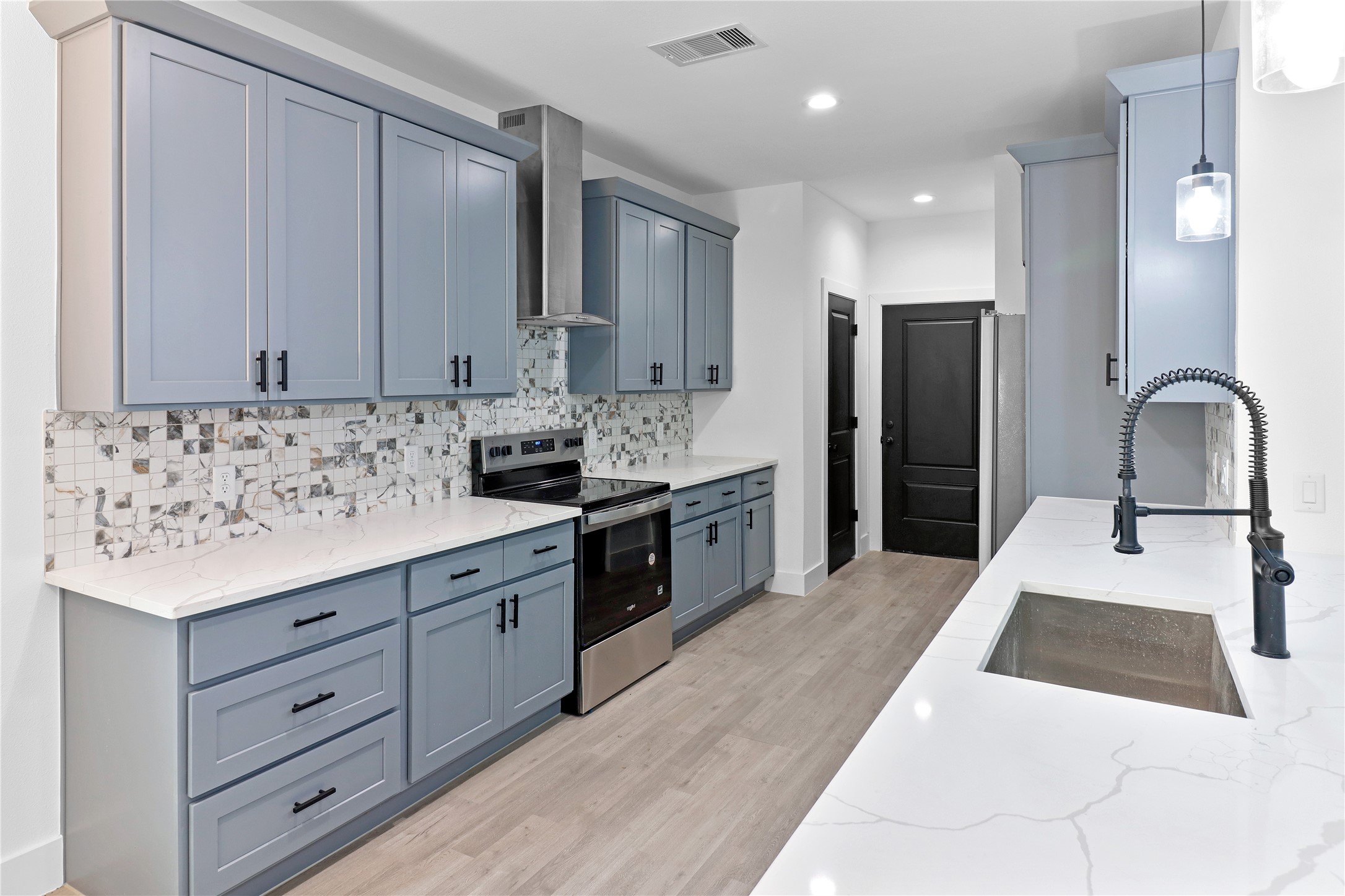 8136 Chateau Street Houston, TX 77028 - Photo 5 of 33 a kitchen with granite countertop white cabinets and stainless steel appliances