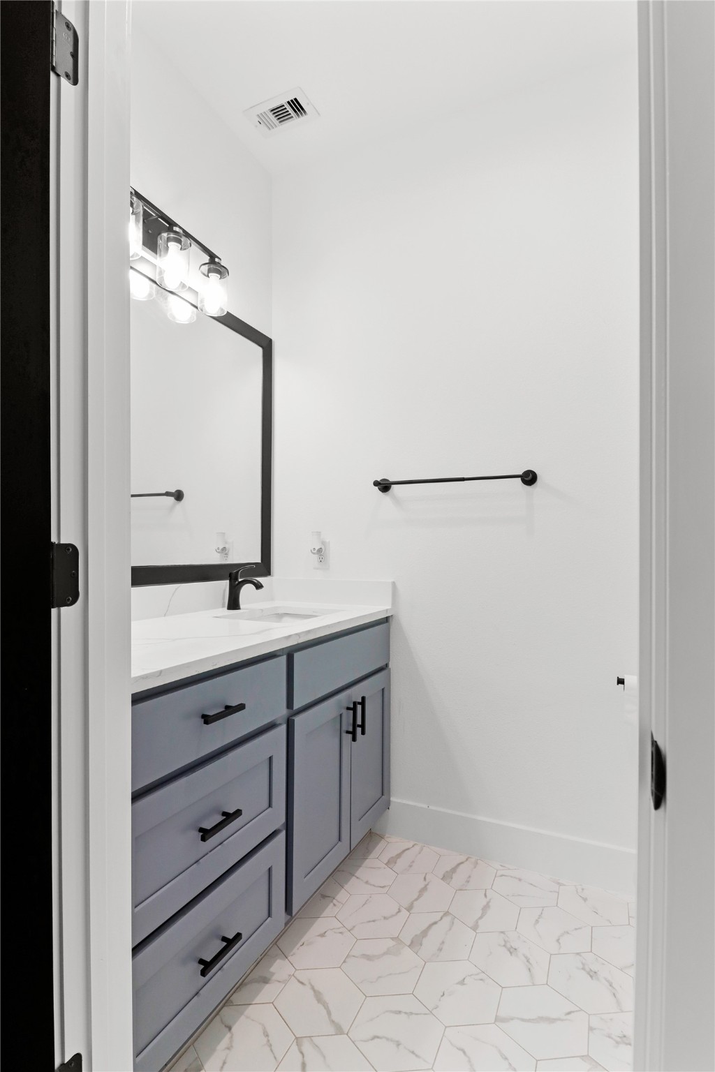 8136 Chateau Street Houston, TX 77028 - Photo 8 of 33 a bathroom with a double vanity sink and mirror