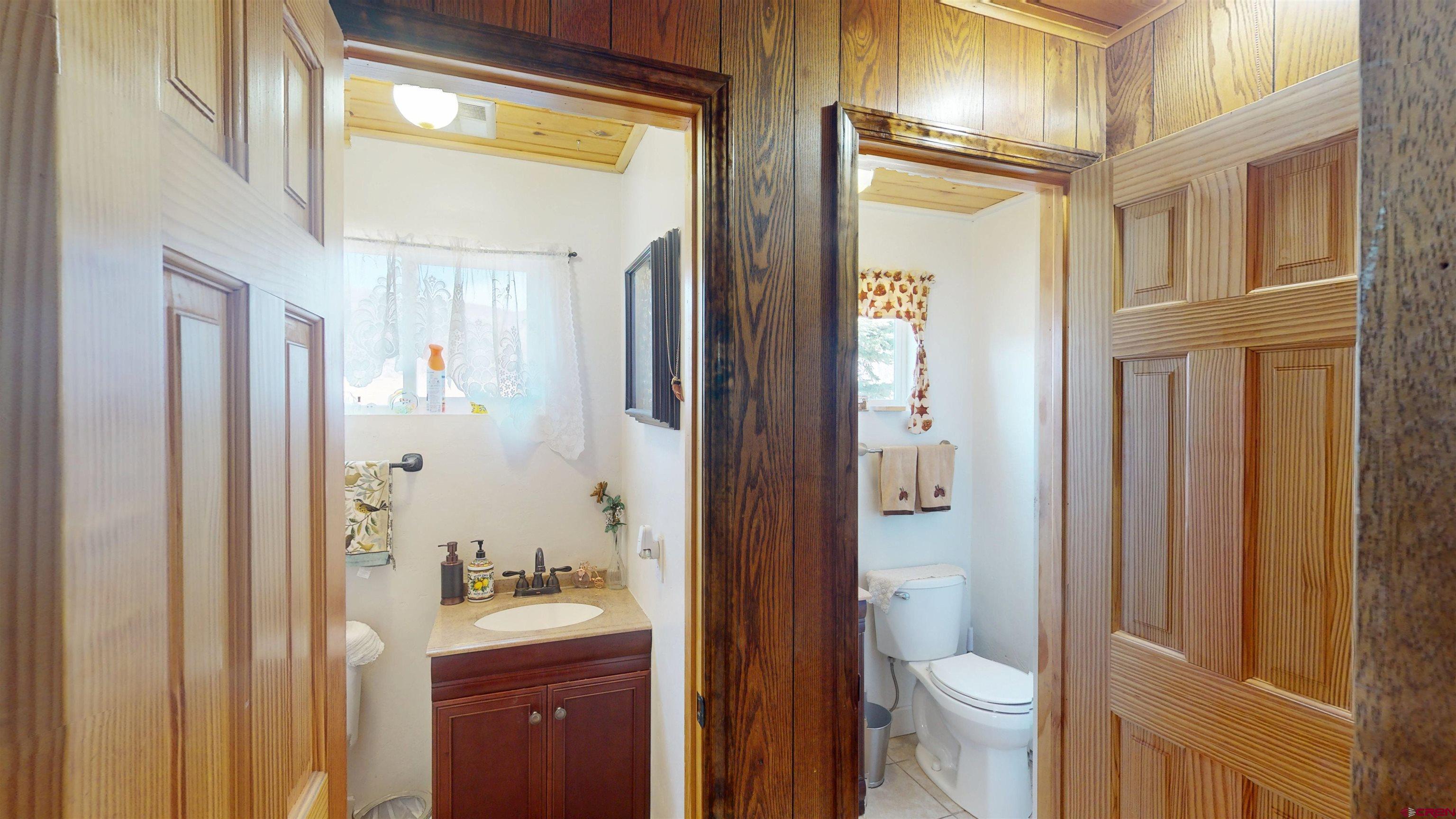 19253 Stevens Gulch Road Paonia, CO 81428 - Photo 28 of 43 a bathroom with a granite countertop sink toilet and shower