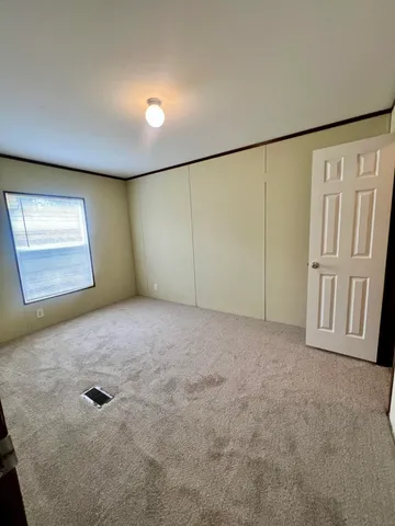 an empty room with a empty space and windows