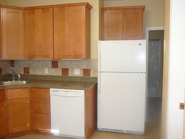 4 Guild Road Worcester, MA 01602 - Photo 17 of 30 a kitchen with a refrigerator and a stove