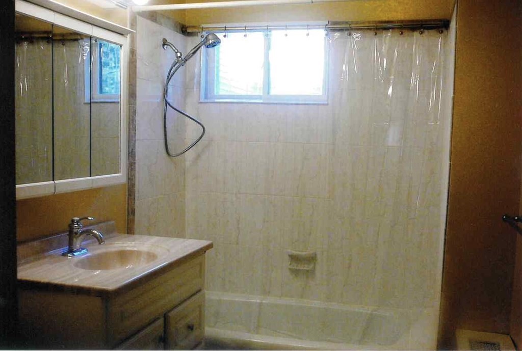 4 Guild Road Worcester, MA 01602 - Photo 26 of 30 a bathroom with a sink vanity mirror and shower