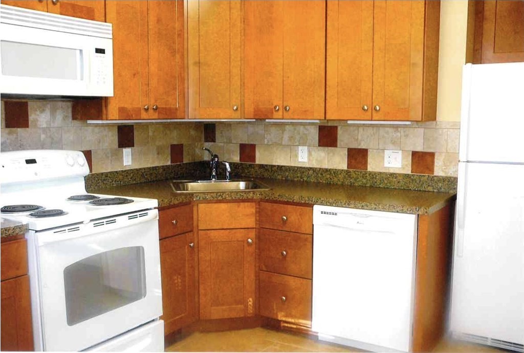 4 Guild Road Worcester, MA 01602 - Photo 30 of 30 a kitchen with granite countertop cabinets and black appliances